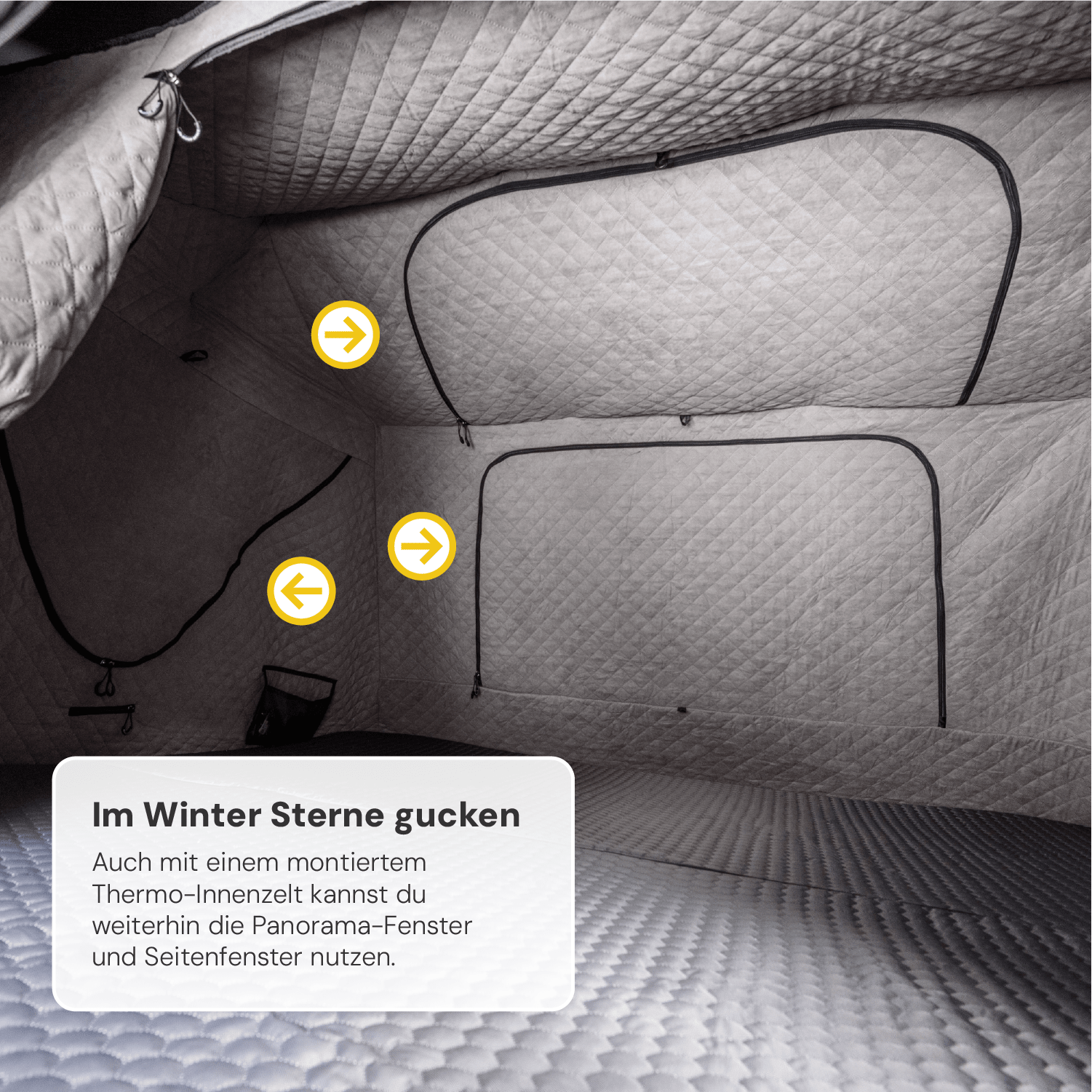 Innenansicht eines grauen Zeltes mit gesteppter Innenausstattung und schwarzen Fensterrahmen; Text "Im Winter Sterne gucken" unten links.