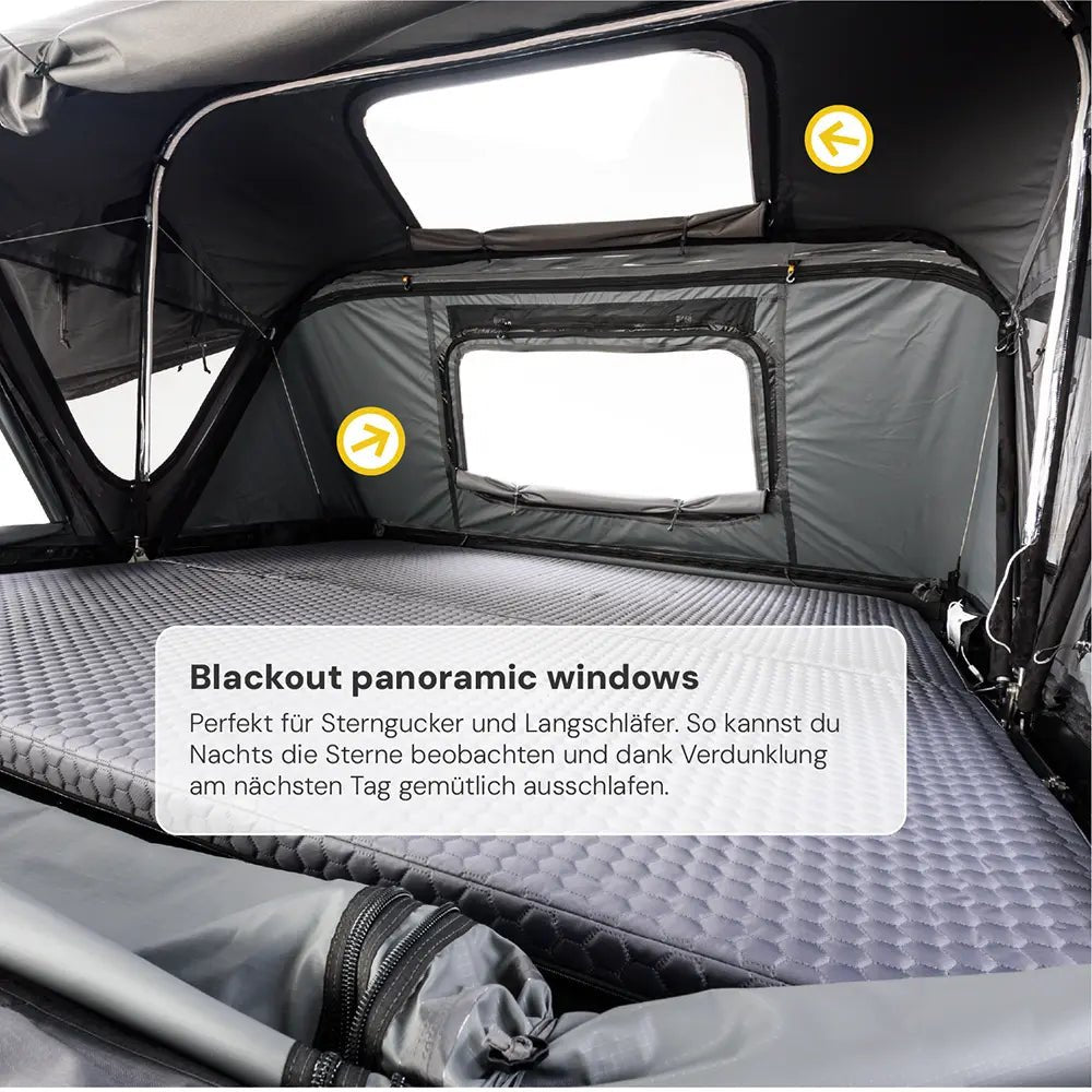 Interior view of a rooftop tent with a grey mattress, panoramic windows, and blackout blinds; text: "Blackout panoramic windows".