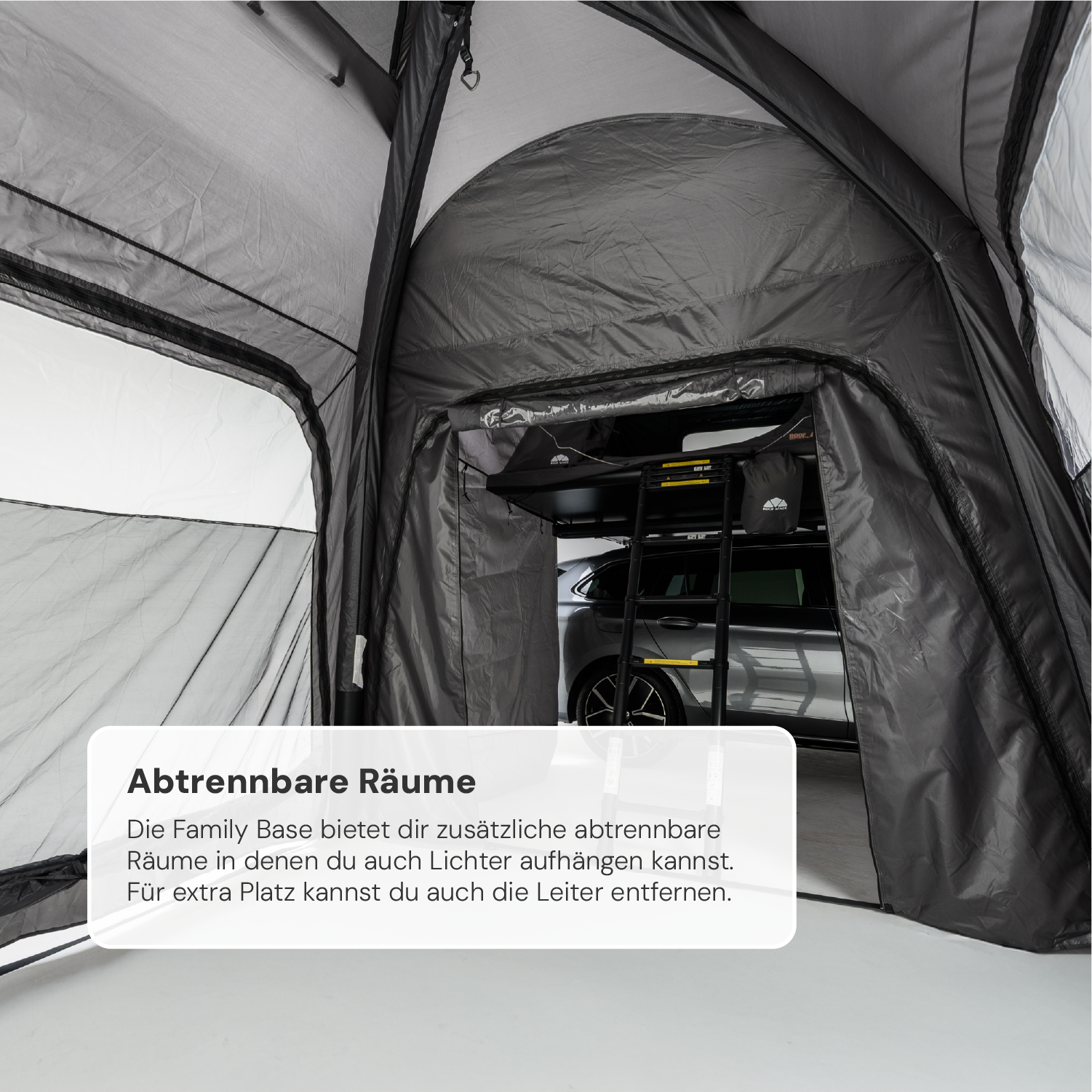 Innenansicht eines grau-schwarzen Zeltes, das an einem Auto befestigt ist, mit Text "Abtrennbare Räume".