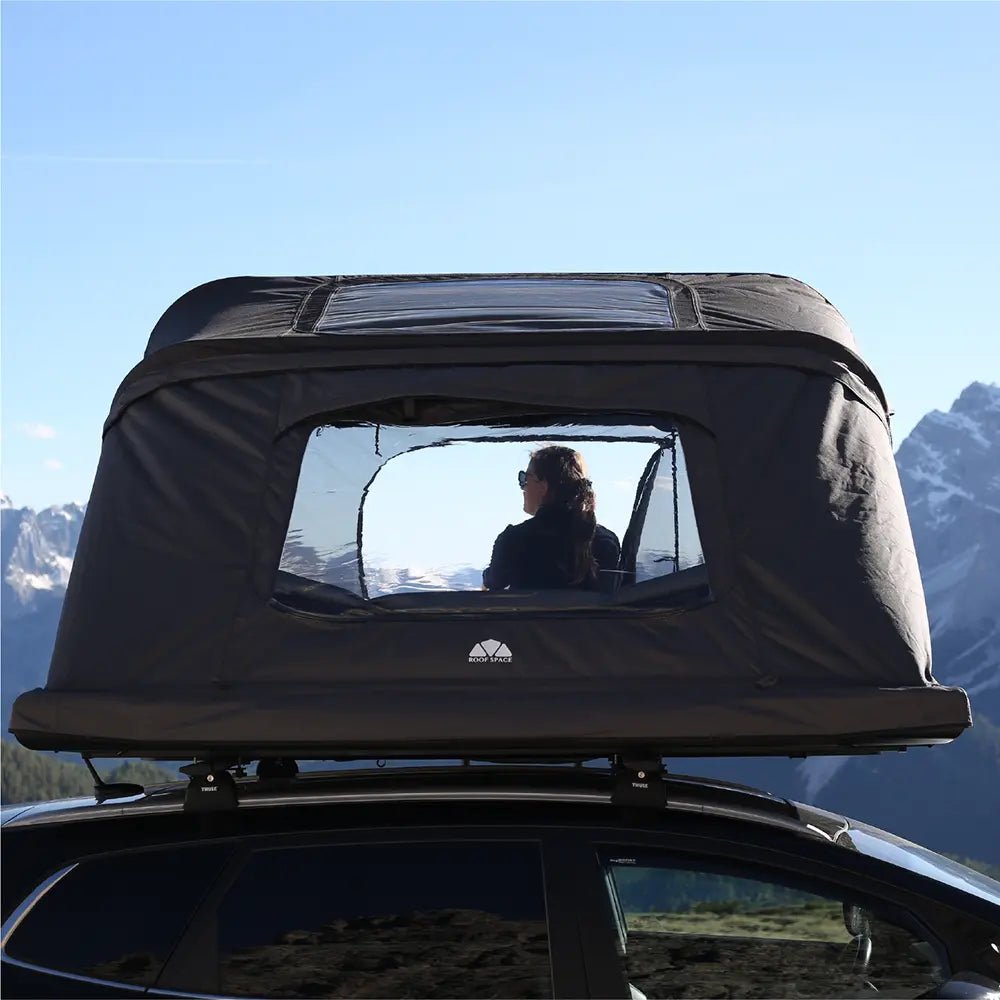 A person, sitting in the Roof Space 4, enjoying the panoramic mode with mountainview