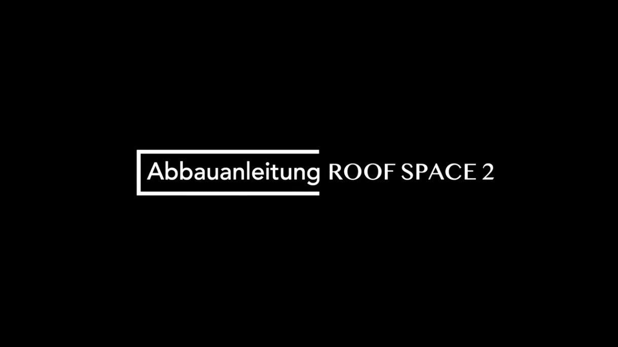 Schwarzer Hintergrund mit weißem Text "Abbauanleitung ROOF SPACE 2", wobei "Abbauanleitung" in einem weißen Rechteck steht.